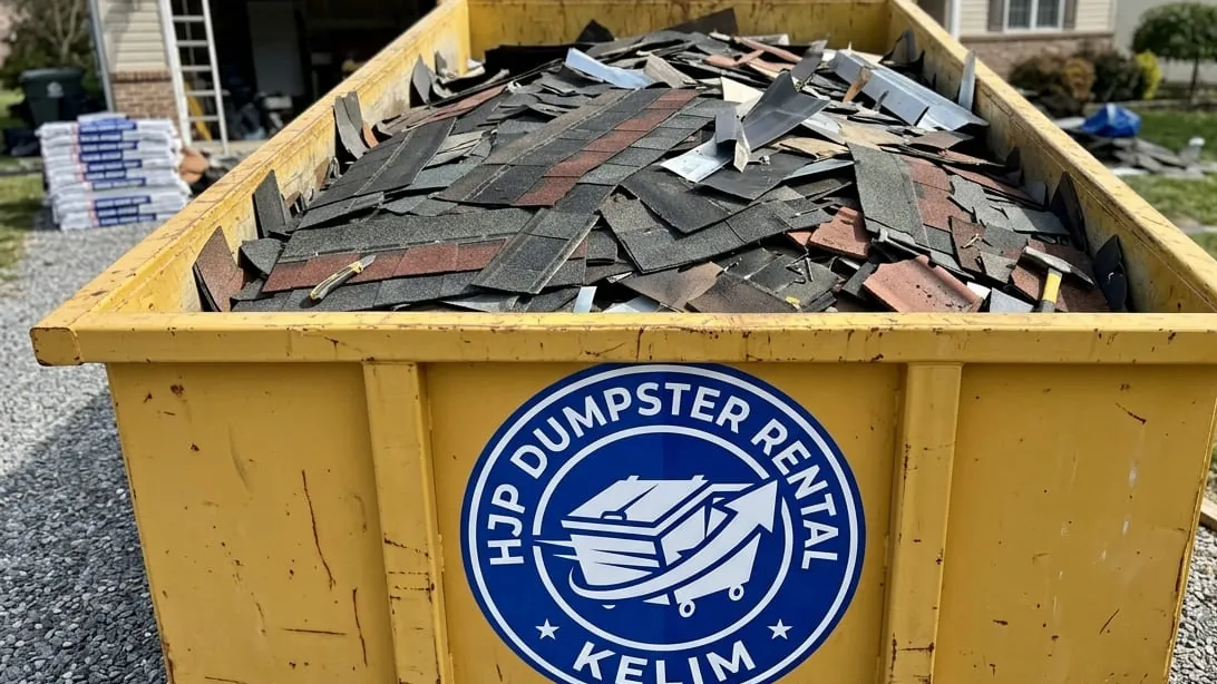 Flood and storm debris cleanup in Kelim, Colorado — wind-thrown and water-damaged material loaded after a Front Range storm